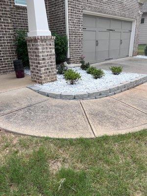 Stone border, fresh landscaping gravel and shrub install