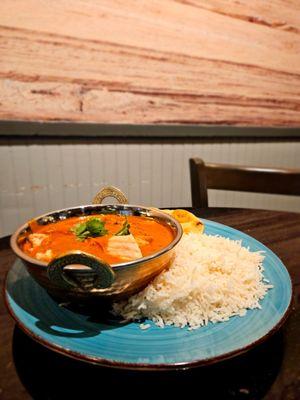 grilled in an authentic coconut milk curry, basmati rice, cilantro and naan bread