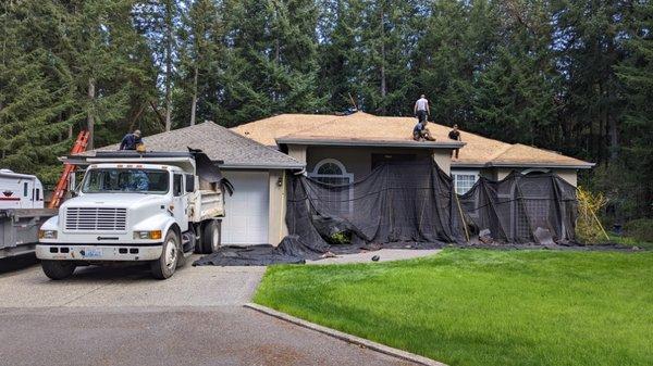 Fox Island roof replacement - showing the great tarp system we use to protect the house and landscaping.