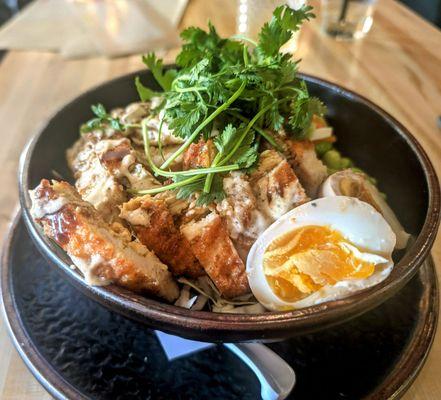 KATSU CHICKEN BOWL Crispy chicken, shoyou egg, shredded cabbage, edamame, pickled carrots, cilantro, sesame garlic aioli, katsu sauce