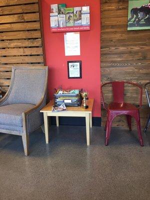 One of two normal sized chairs (left) compared with one of many child sized chairs (right) that adorn the waiting room area.