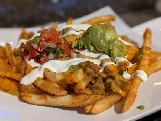 Shredded pork chile verde fries with sour cream, guacamole and pico.