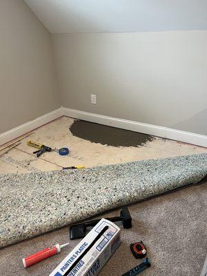 The floor board was uneven and you could touch your hand under the baseboard. They came back and this was their solution.