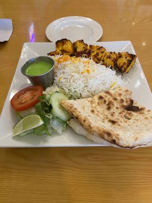 Chicken breast kabob with rice, salad and bread