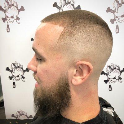 Haircut description: Mid-high bald fade #2 guard with beard line up and shaped up.