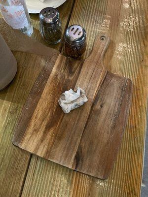 They serve their pizzas on wooden cutting boards when you eat in