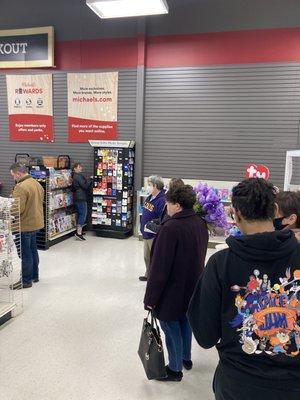 Long ridiculous lines of customers awaiting to checkout items.