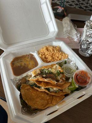 Birria Tacos with rice and beans.