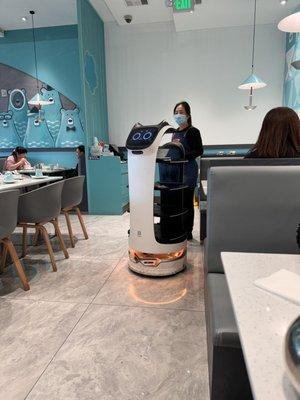 Robot waiter brings out food on the tray