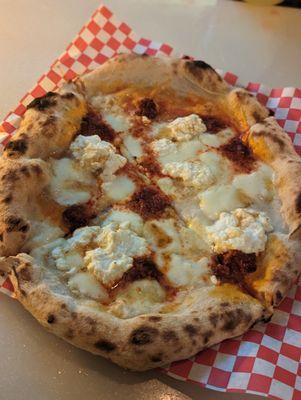 Monalizza Pizza - mozzarella, ricotta, spicy 'nduja sausage, roasted tomatoes and Mike's hot honey.