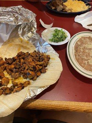 Tacos al pastor (front) and carnitas with rice only (back)