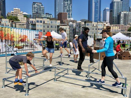 Students of all ages play on a rail scaffolding set we designed. Community event held at the Waterfront Pier 62 in 2021.