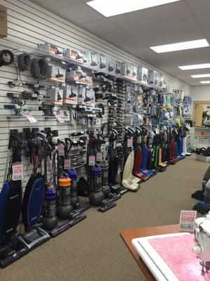 Vacuums along the left wall of the store