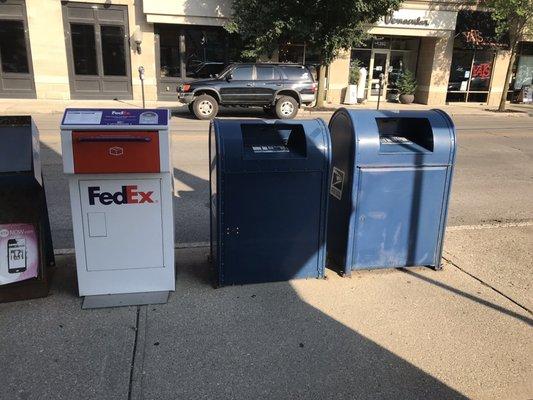 There is also a FedEx box next to the two USPS Blue Boxes.