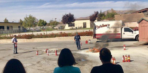 Outdoor fire extinguisher demonstration with Soledad Comminity Healthcare District staff.