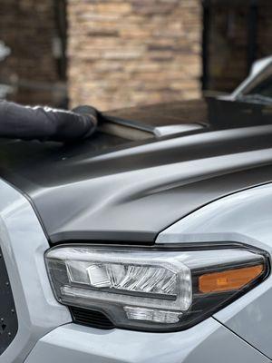 Here we are finishing a Satin Black in 3M vinyl 
Hood on this 2022 Toyota Tacoma to give it a nice accent