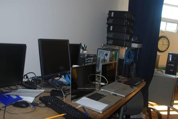 Metro Computerworks LLC workbench with Mac laptops