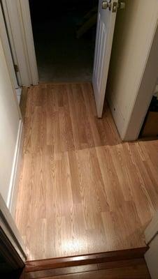 Installed interlocking laminate flooring with lots of corners, thresholds and irregularities.