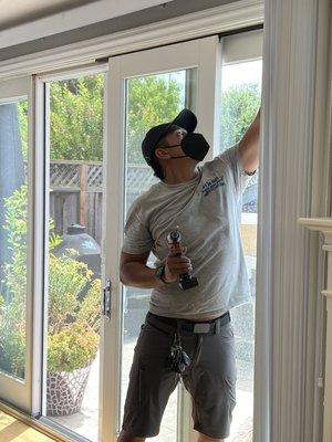 Kevin repairing an Anderson sliding glass door.