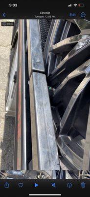 Rim against metal rail on tow truck scratching it