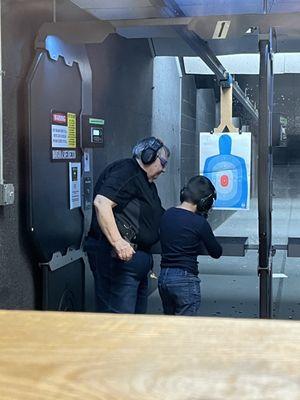 Carol teaching my grandson gun safety.