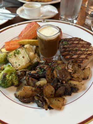 Petite Filet Mignon with au jus and veggies with potatoes