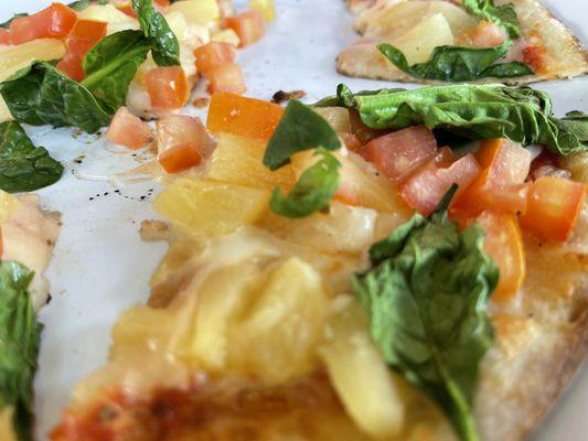 Pineapple, spinach, tomato pizza