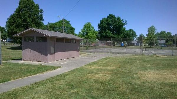 restroom and tennis courts both look in need of attention