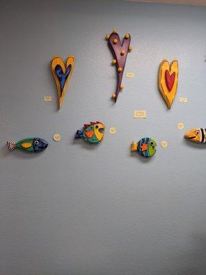 Fun and colorful handmade wood hearts and fish with lots of personality to enliven your walls.