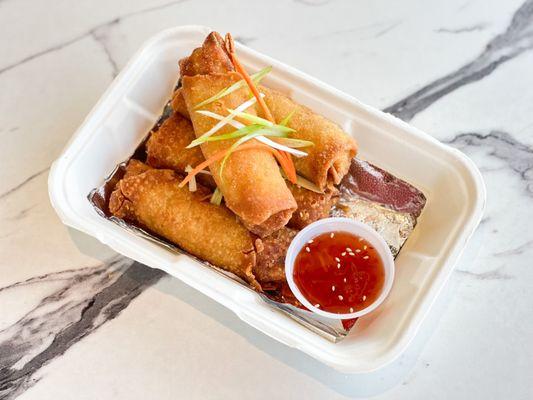 Crispy chicken and veggie egg rolls served with side of sweet chili sauce