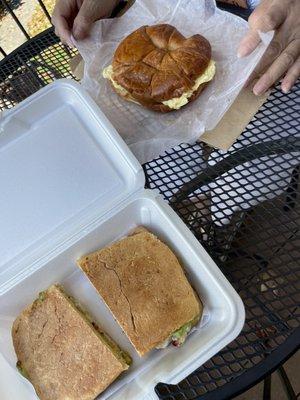 Bacon egg and cheese on croissant & chicken panini with avocado spread, lettuce, and cranberries.