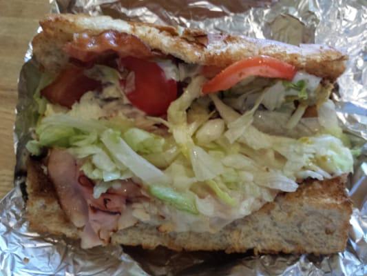 A half Planet Sub Sandwich.  Tasty and warm, but the lettuce and tomatoes are warm too.