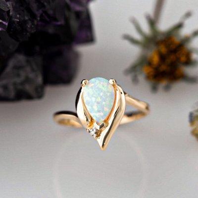 Dreamy opal and diamond ring set in 14k yellow gold.