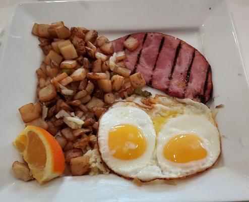 Country potatoes, ham, and sunny side up eggs