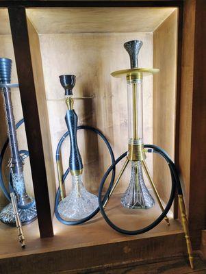 This is a photo of some floor standing hookahs. They are a popular item at this shop.