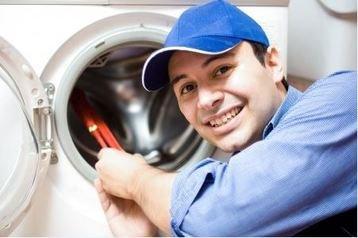 Professional repairman fixing washer.