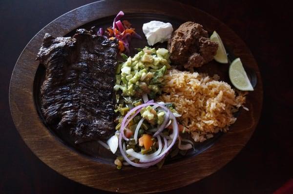 Arrachera steak served with beans rice and cactus salad