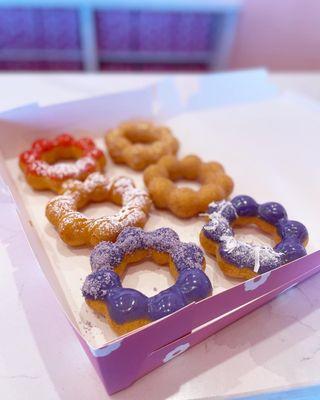 @eat_with_jeleneeee | Ube sugar, Ube Coconut, Churro, Caramel Funnel Cake, Strawberry Mango, & glazed