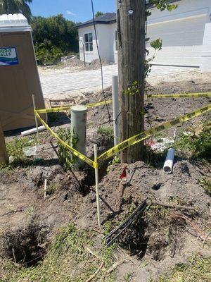 Four to five foot hole around utility telephone pole with transformer on top