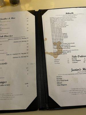 The menu has old paper with stains and tears