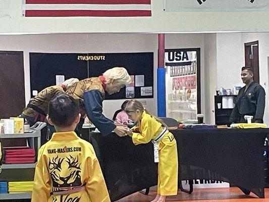 Our daughter receiving her belt