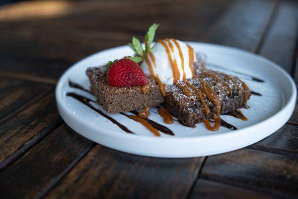 Home-made brownies with vanilla ice cream, caramel drizzle