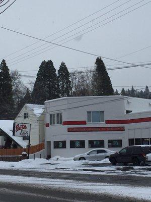 Storefront and small parking lot.