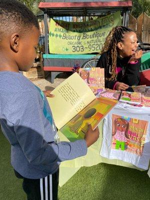 Author Kimally Samuels reads her children's book "Micah and the Vase" at Analog Dope.