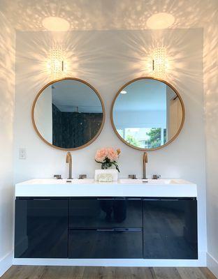 Navy blue floating vanity, acrylic white countertops.