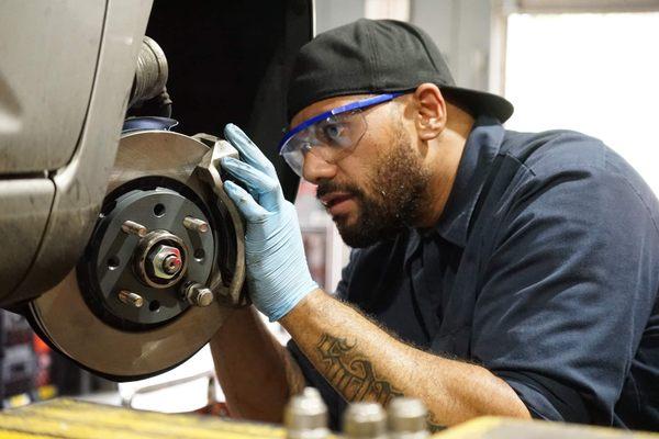 Technician Pele installs some much-needed brake pads.