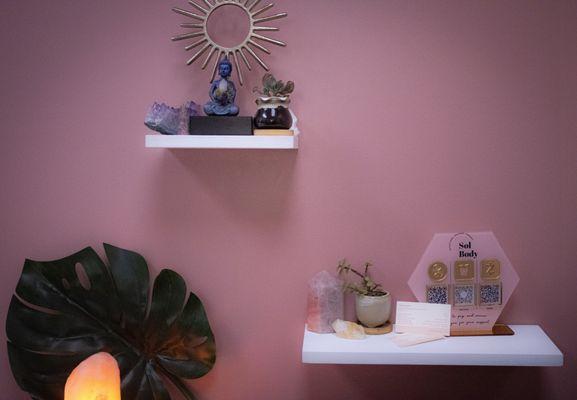 Cute wall set up of crystals on her shelves.