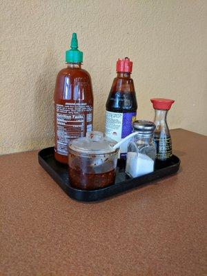 Condiments, a cap on a bottle missing (this was visualized on several tables)