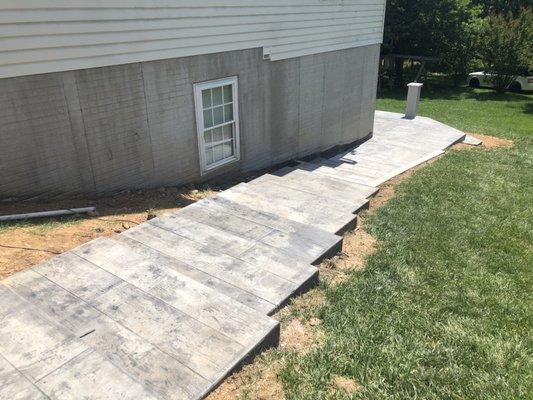 Excavation and Grading contractors of Dirt Devil Landscaping performing stamped concrete installation services in Woodstock, MD