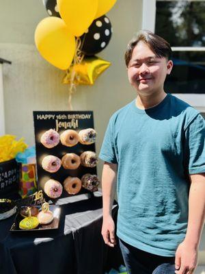 Balloons behind his donut wall!